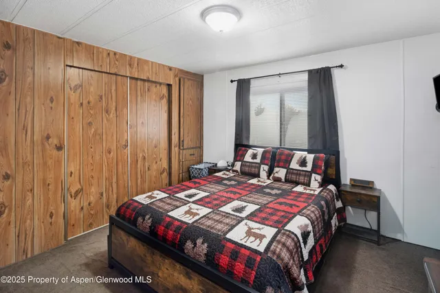 a bedroom with a bed and a mirror