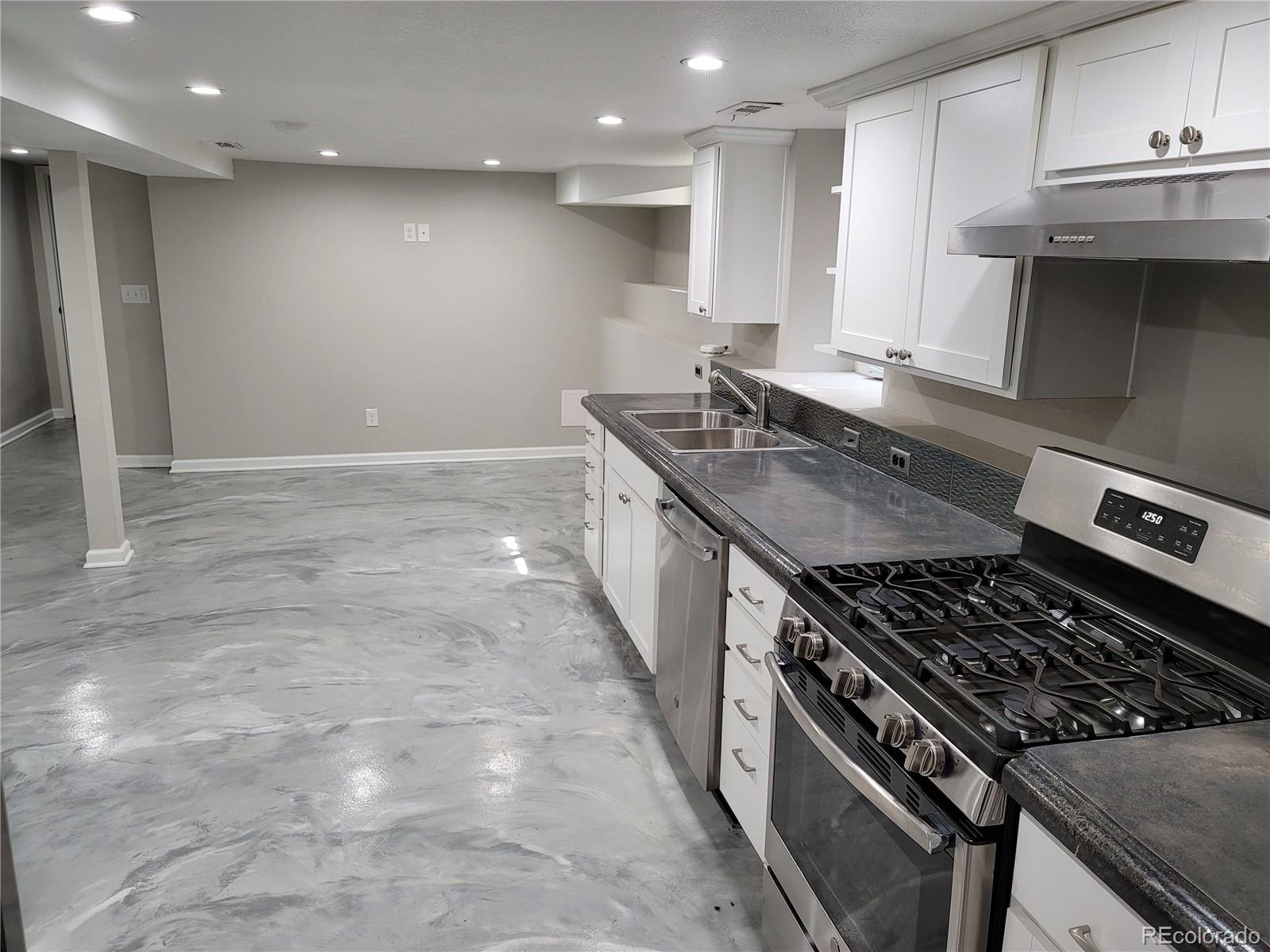 2834 Curtis Street, Unit 3 Denver, CO 80205 - Photo 9 of 22 a kitchen with stainless steel appliances granite countertop a stove and a sink