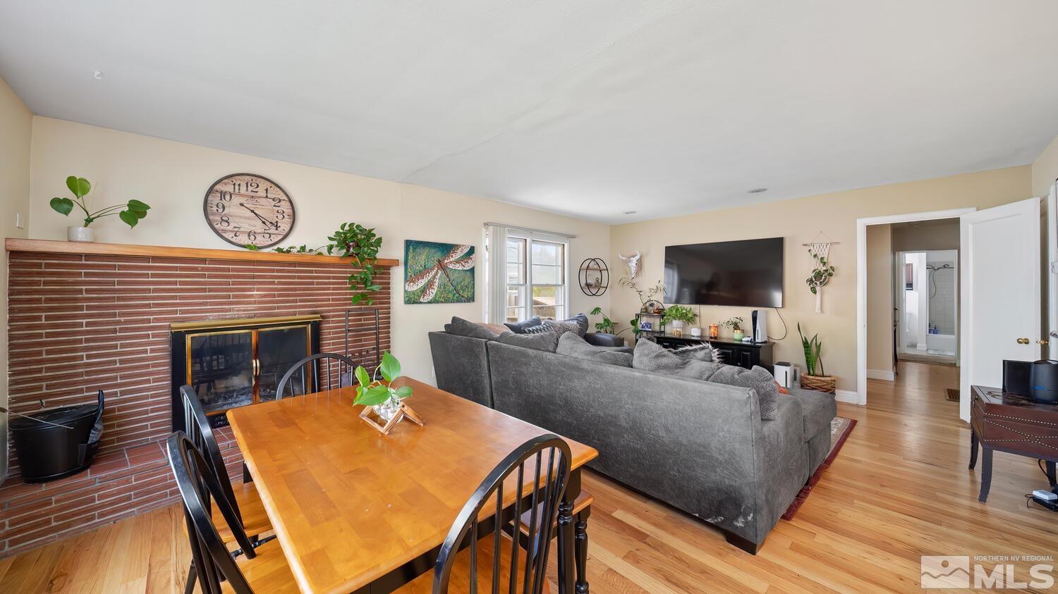 1360 Faland Way Reno, NV 89503 - Photo 8 of 26 a living room with furniture a fireplace and a flat screen tv
