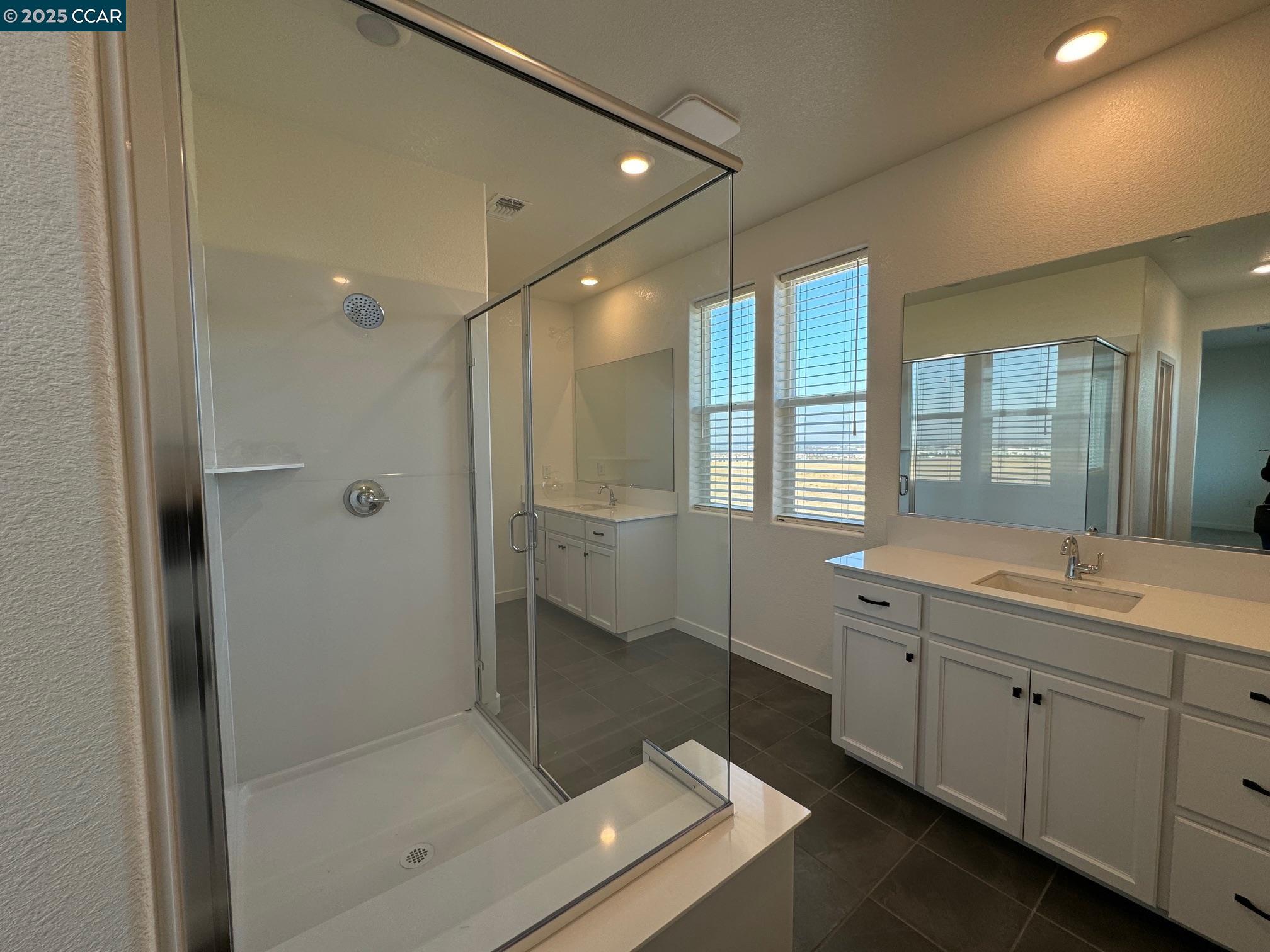 4786 Cantrell Drive Folsom, CA 95630 - Photo 20 of 30 a bathroom with a shower sink and mirror