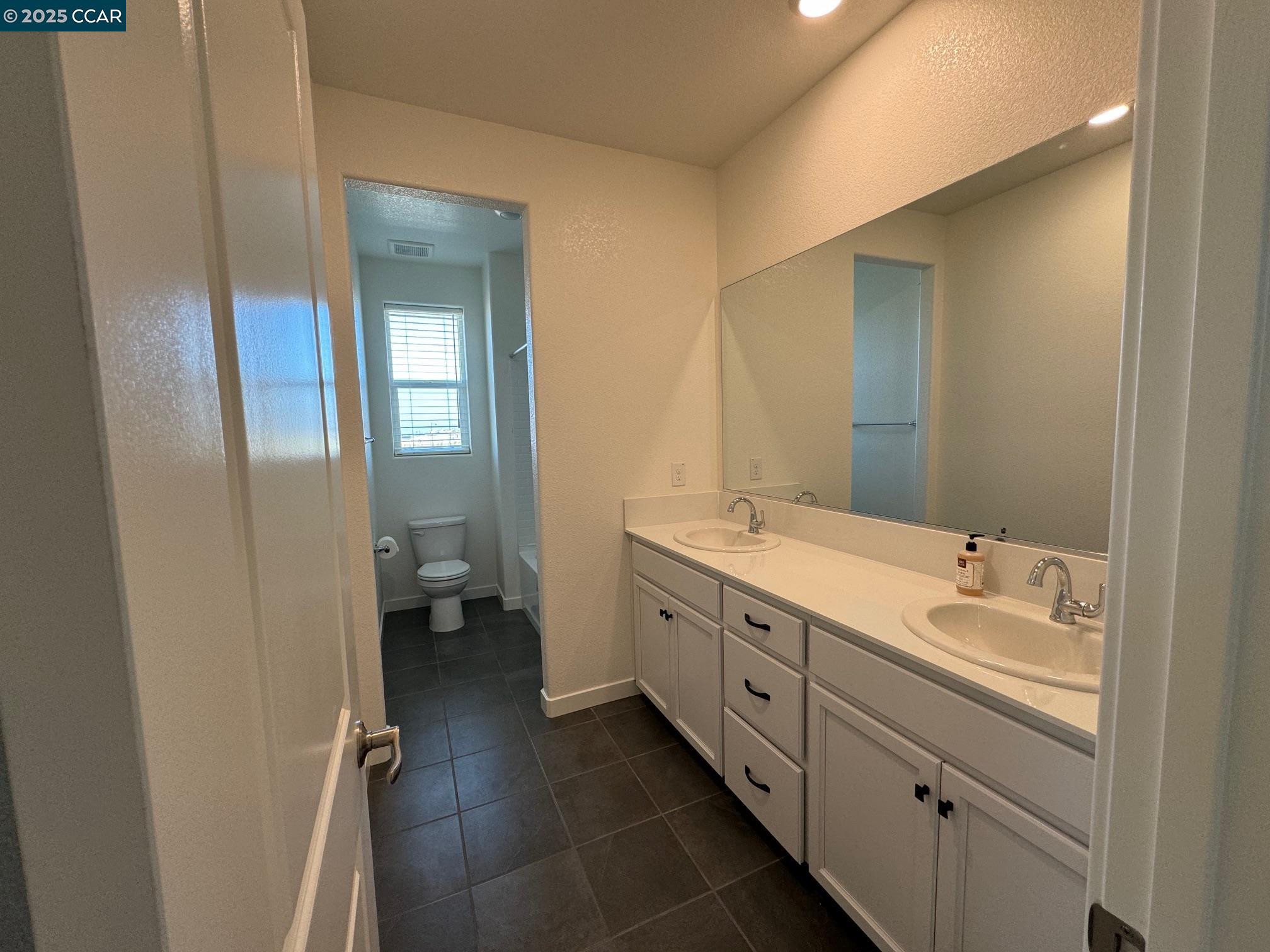 4786 Cantrell Drive Folsom, CA 95630 - Photo 24 of 30 a spacious bathroom with a double vanity sink a mirror and a shower