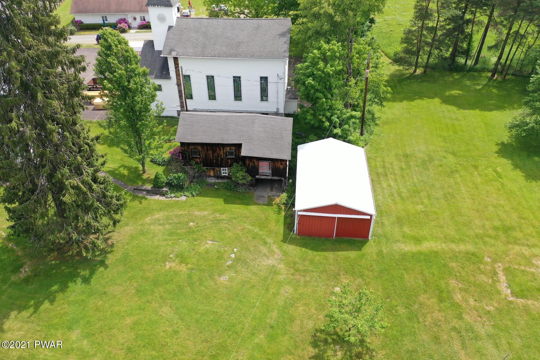 20 Pond Road Moscow, PA 18444 - Photo 15 of 59 a aerial view of a house with swimming pool lawn chairs and a yard