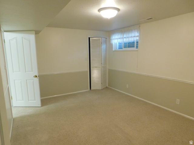 2148 Carolyn Way Bountiful, UT 84010 - Photo 20 of 40 Spacious room with neutral carpet flooring and two-tone painted walls