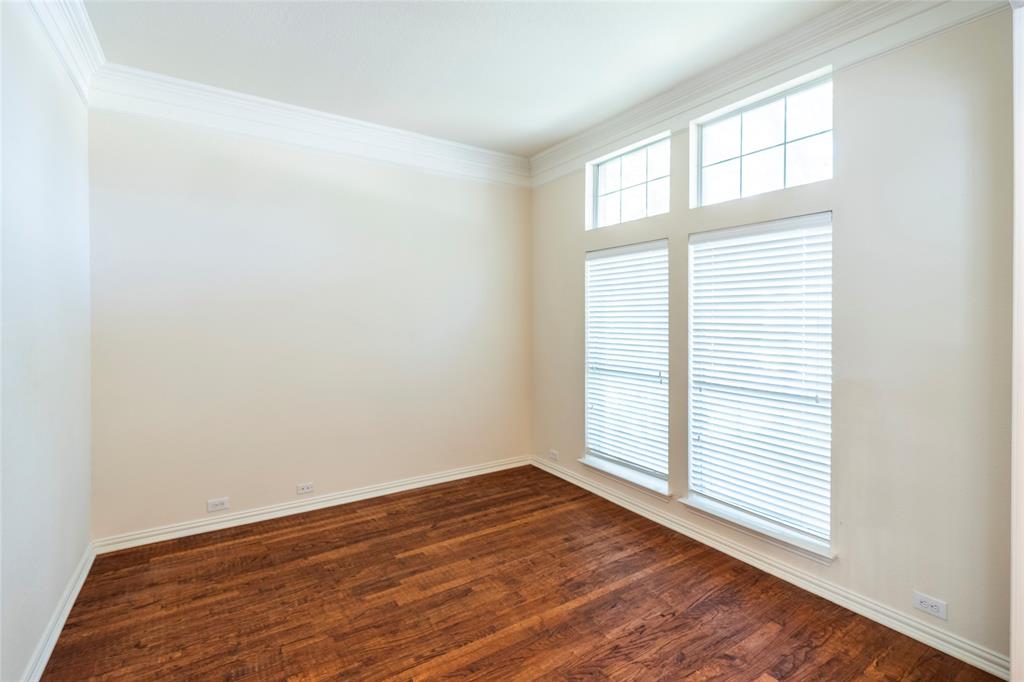 220 Justin Road Murphy, TX 75094 - Photo 7 of 40 Unfurnished room featuring dark wood-type flooring, ornamental molding, and baseboards