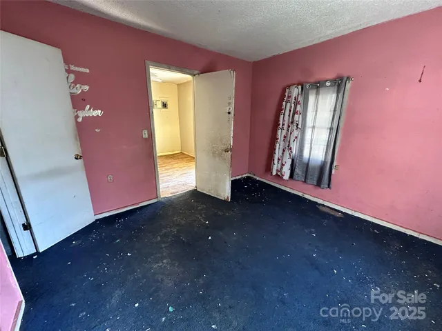 a view of a hallway with wooden walls and a window