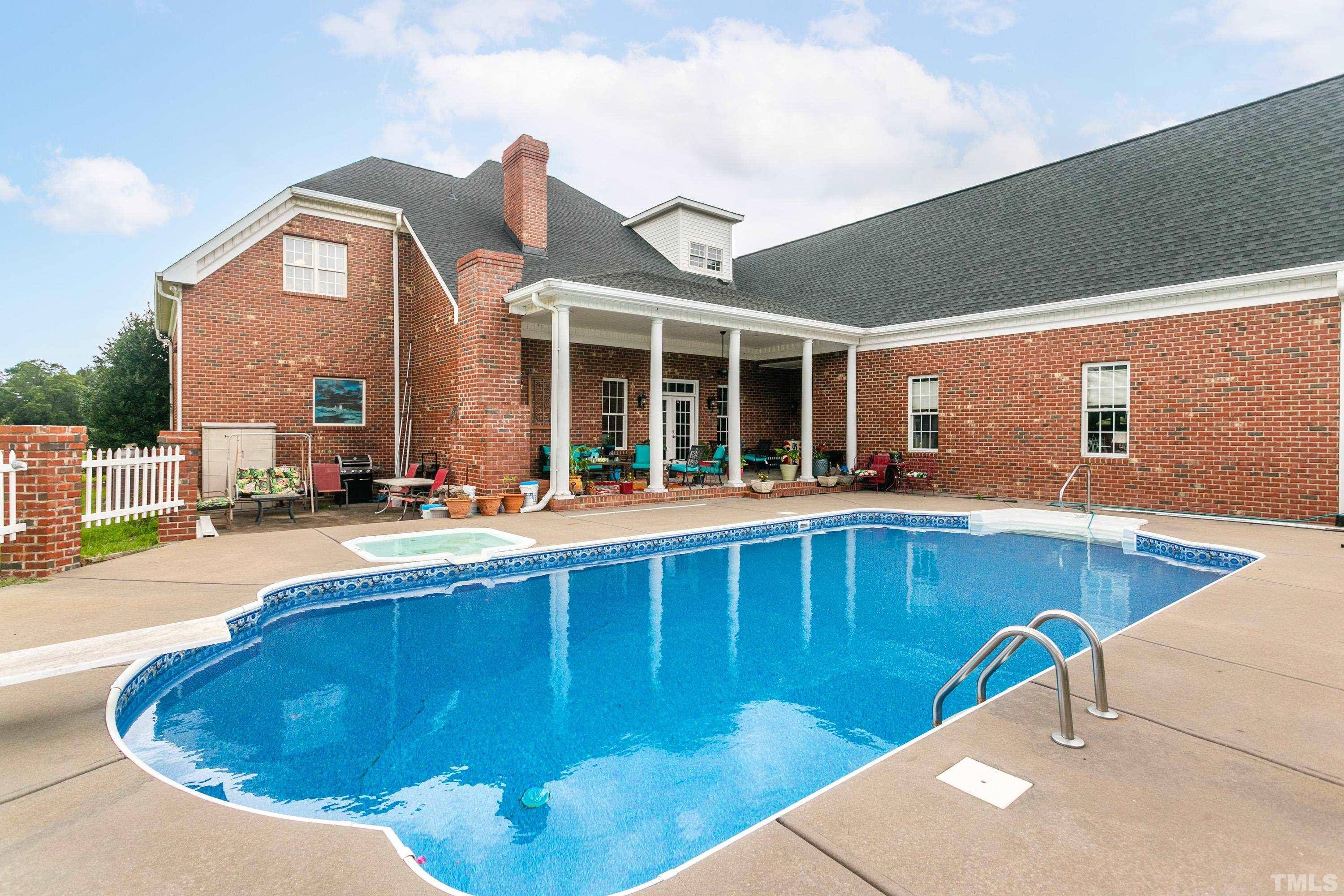 1016 Moss Road Zebulon, NC 27597 - Photo 19 of 30 a view of a swimming pool with outdoor seating