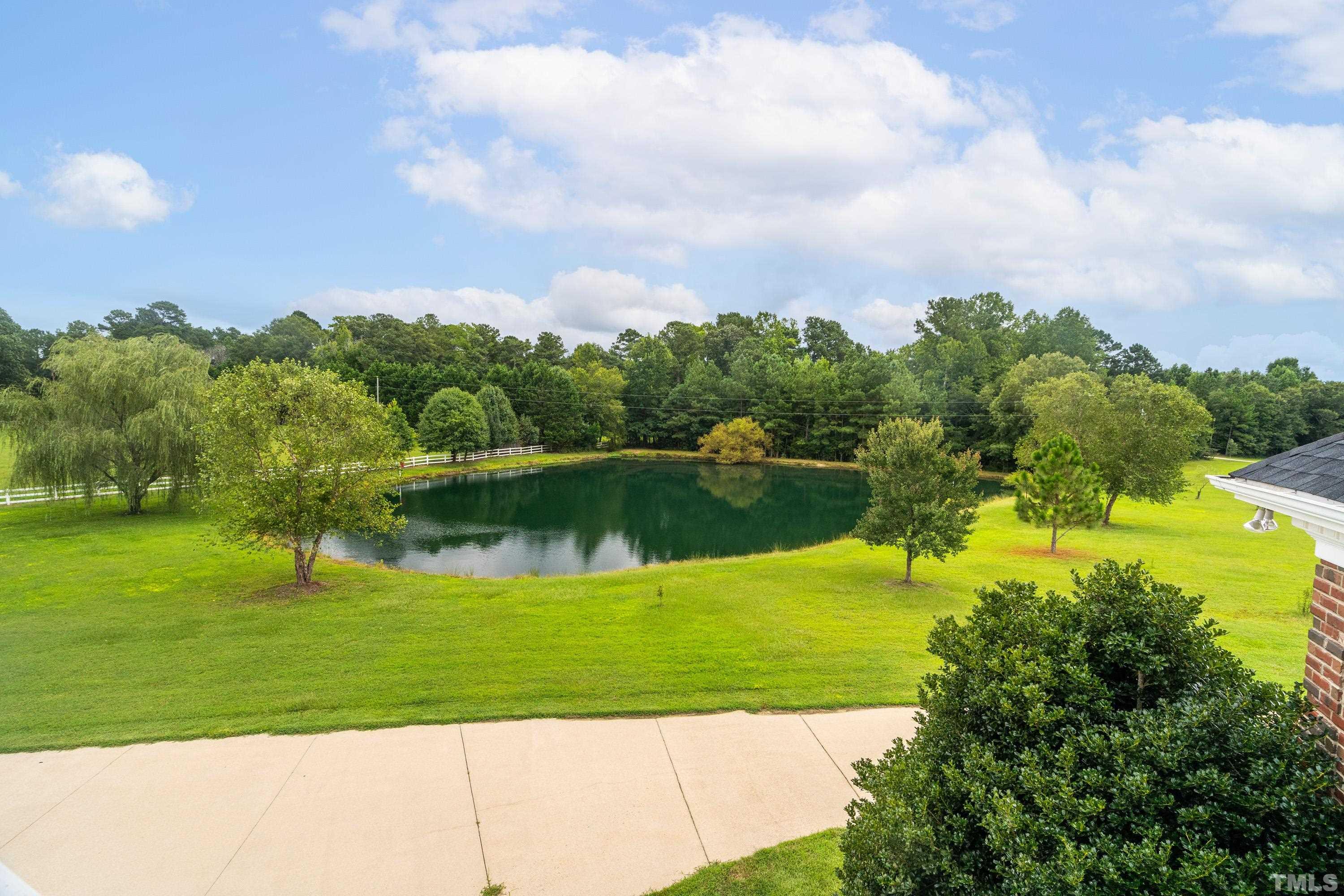 1016 Moss Road Zebulon, NC 27597 - Photo 23 of 30 a view of a lake with a big yard