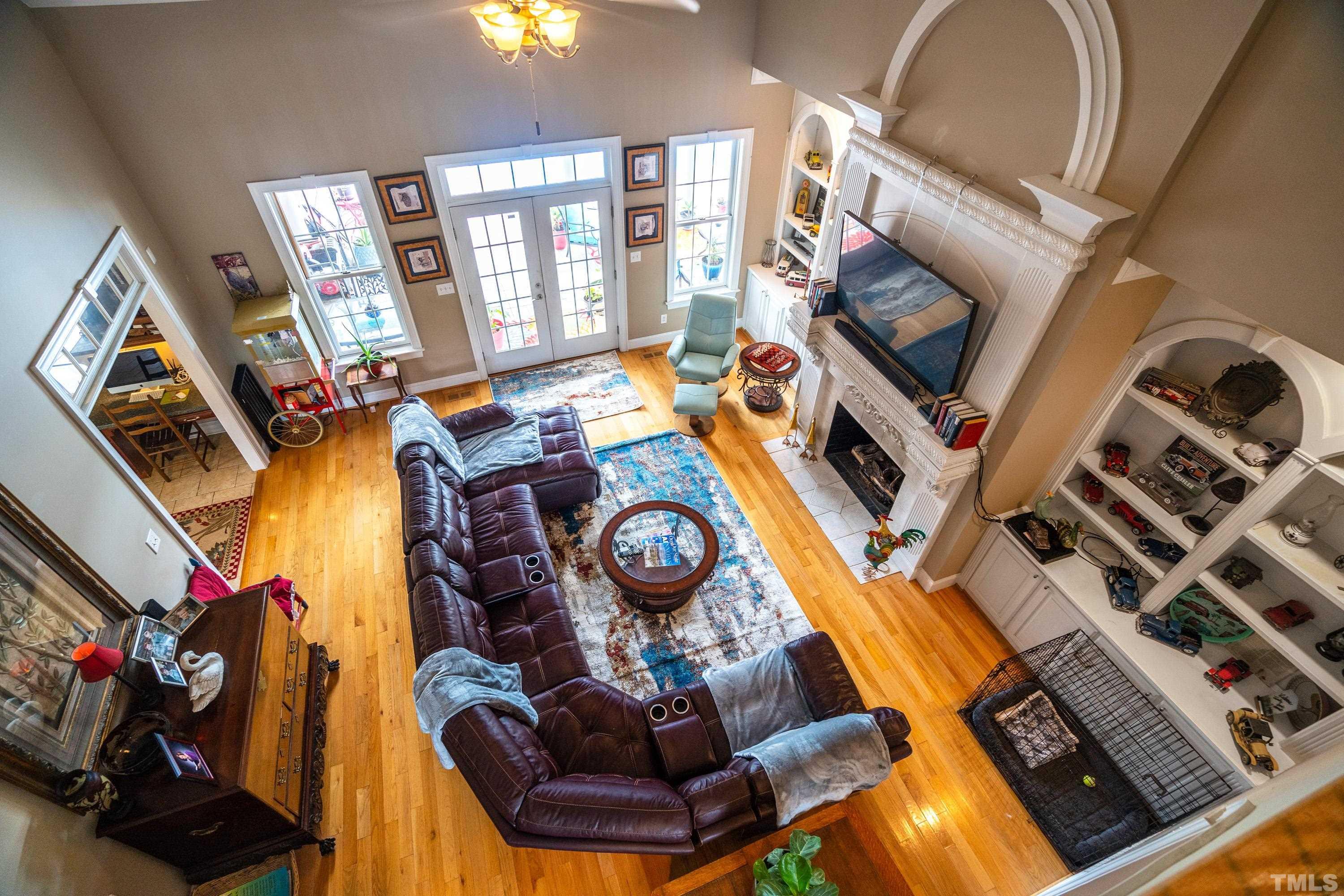 1016 Moss Road Zebulon, NC 27597 - Photo 27 of 30 a living room with furniture a flat screen tv and a fireplace
