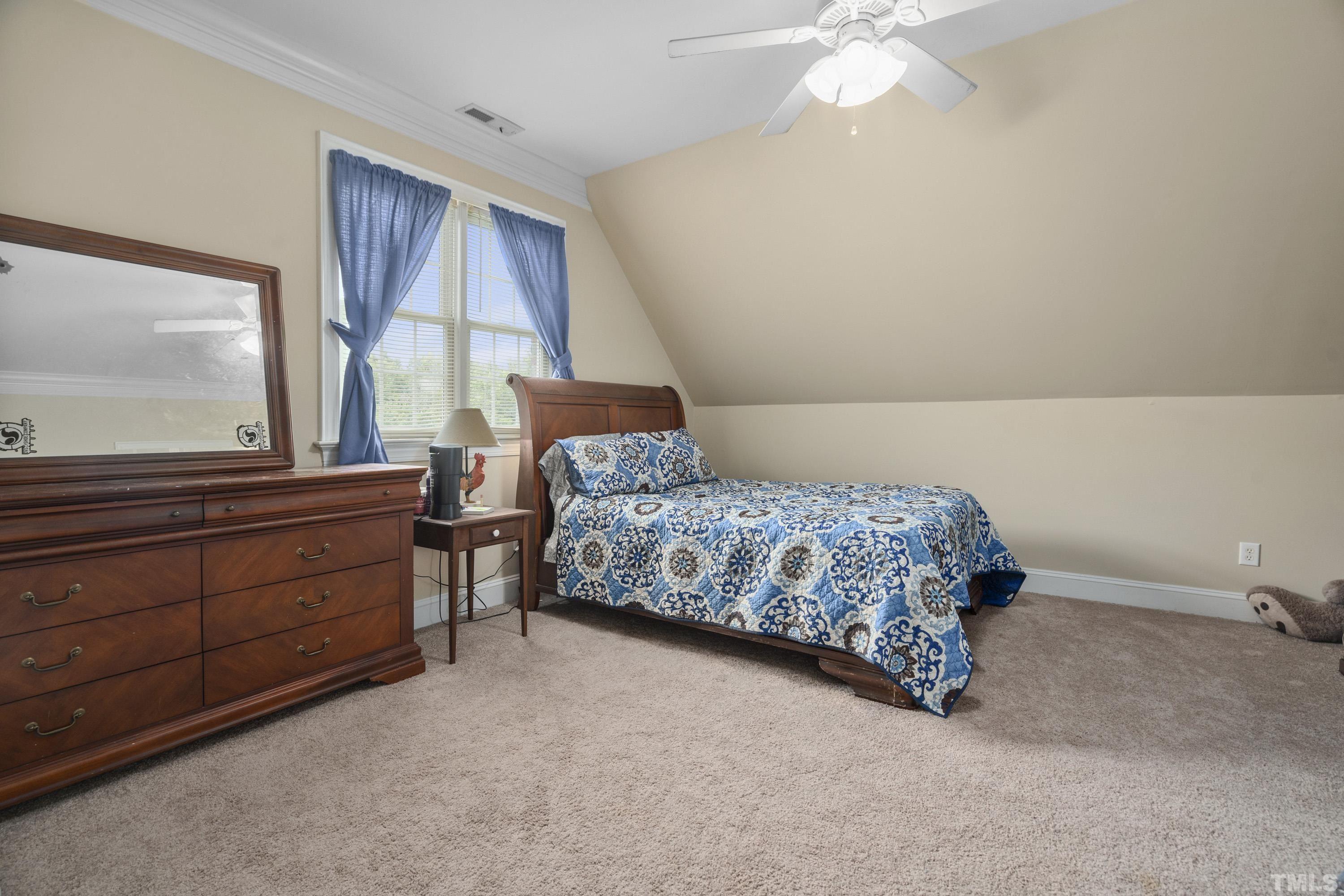 1016 Moss Road Zebulon, NC 27597 - Photo 29 of 30 a bedroom with a bed and a dresser