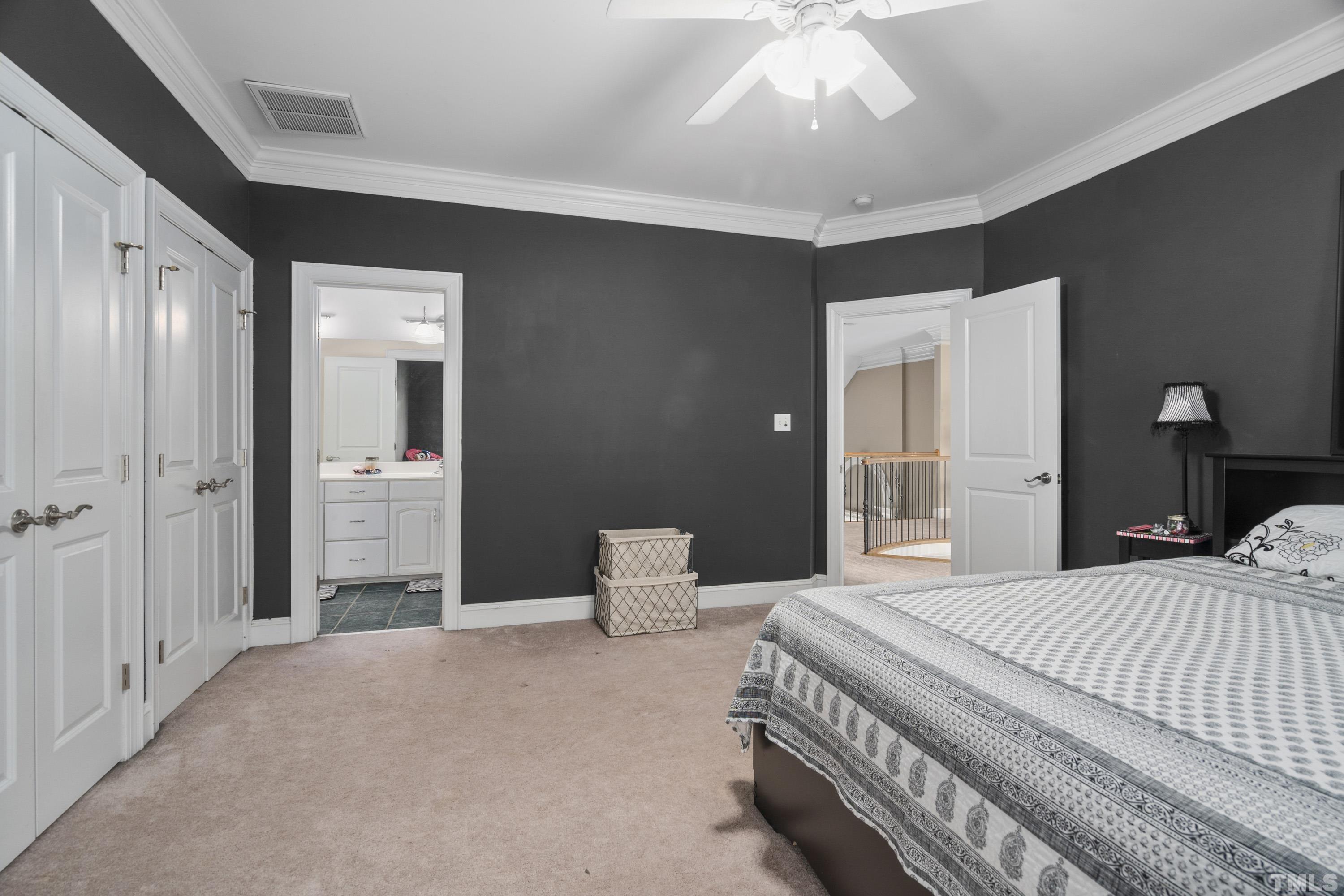 1016 Moss Road Zebulon, NC 27597 - Photo 30 of 30 a bedroom with a bed and a chandelier