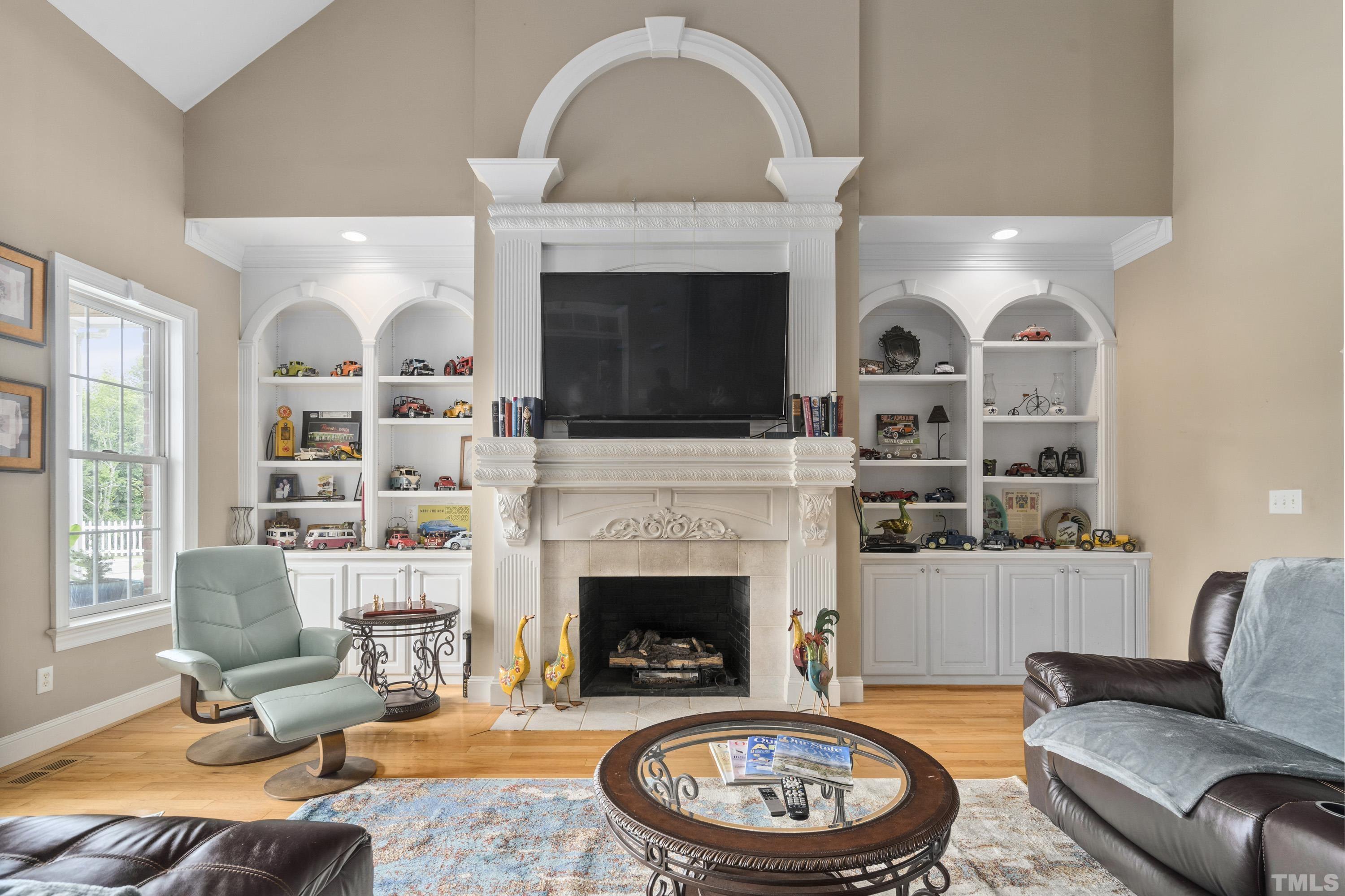 1016 Moss Road Zebulon, NC 27597 - Photo 4 of 30 a living room with furniture a fireplace and a flat screen tv