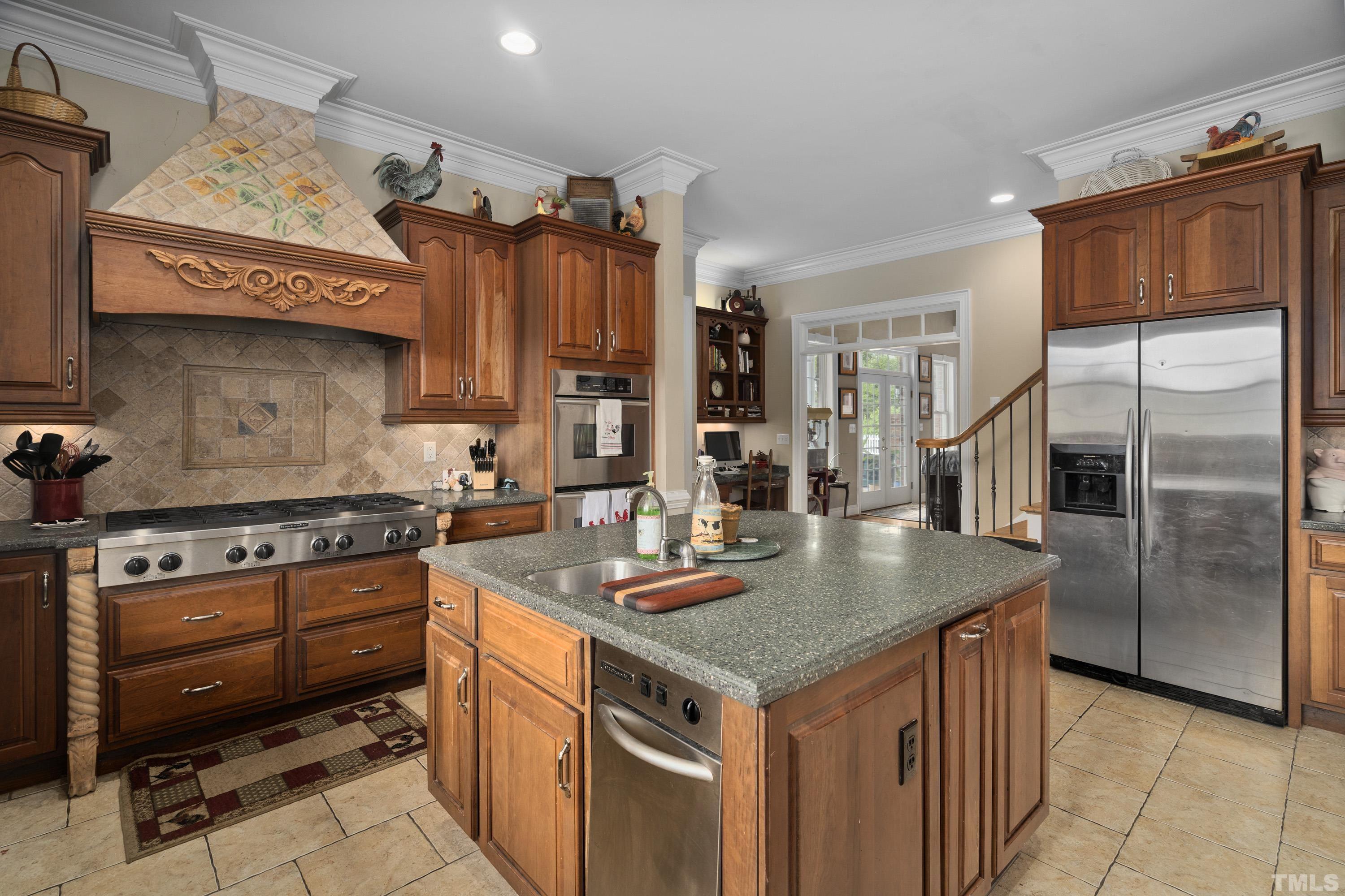 1016 Moss Road Zebulon, NC 27597 - Photo 5 of 30 a kitchen with stainless steel appliances granite countertop a stove refrigerator and cabinets