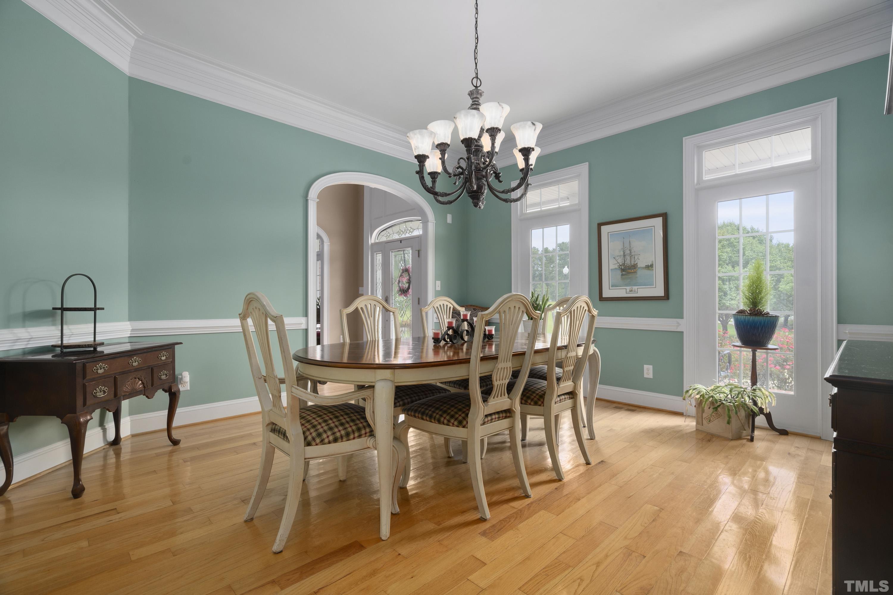 1016 Moss Road Zebulon, NC 27597 - Photo 6 of 30 a view of a dining room with furniture a chandelier and wooden floor