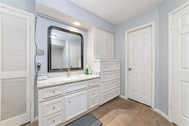 a spacious bathroom with a granite countertop tub sink and shower