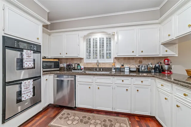 a kitchen with granite countertop a refrigerator and a stove