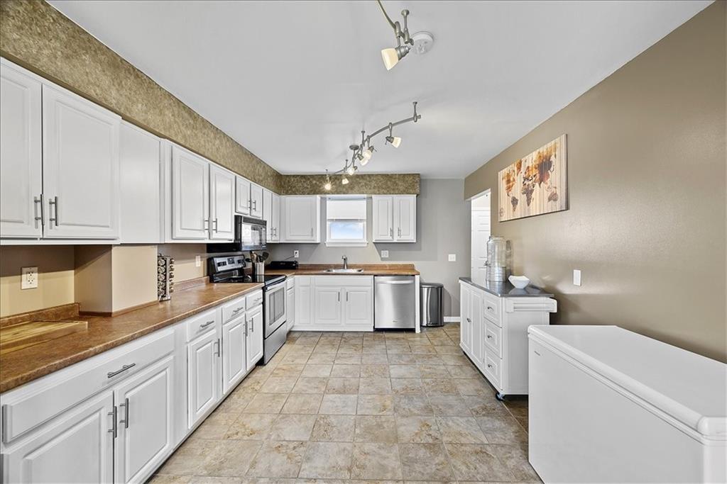 204 Pleasant Ridge Road McKees Rocks, PA 15136 - Photo 11 of 23 a large white kitchen with cabinets