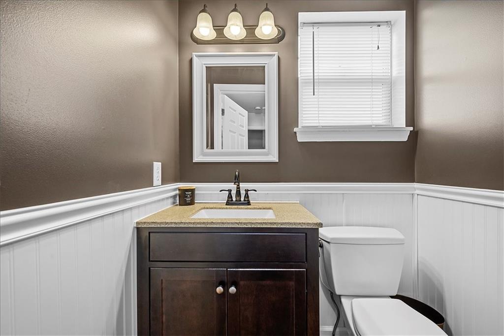 204 Pleasant Ridge Road McKees Rocks, PA 15136 - Photo 13 of 23 a bathroom with a toilet sink vanity and mirror