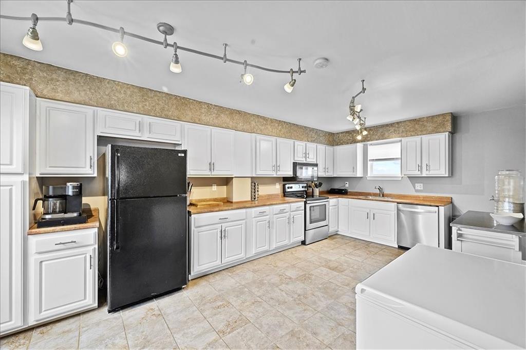 204 Pleasant Ridge Road McKees Rocks, PA 15136 - Photo 10 of 23 a kitchen with a refrigerator a sink and dishwasher