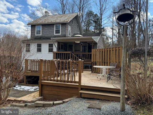 631 McCauley Road Conowingo, MD 21918 - Photo 5 of 32 a view of a deck with table and chairs with wooden floor and fence