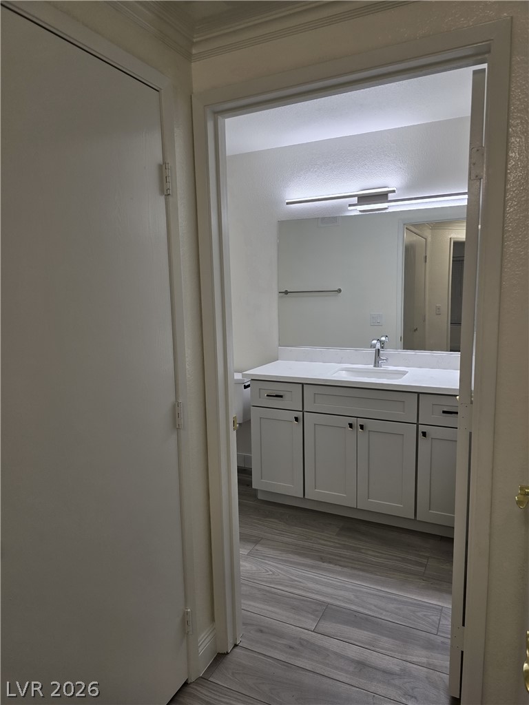 1881 West Alexander Road, Unit 1127 North Las Vegas, NV 89032 - Photo 19 of 20 Refined bathroom with sleek vanity and contemporary wood-look tile flooring.