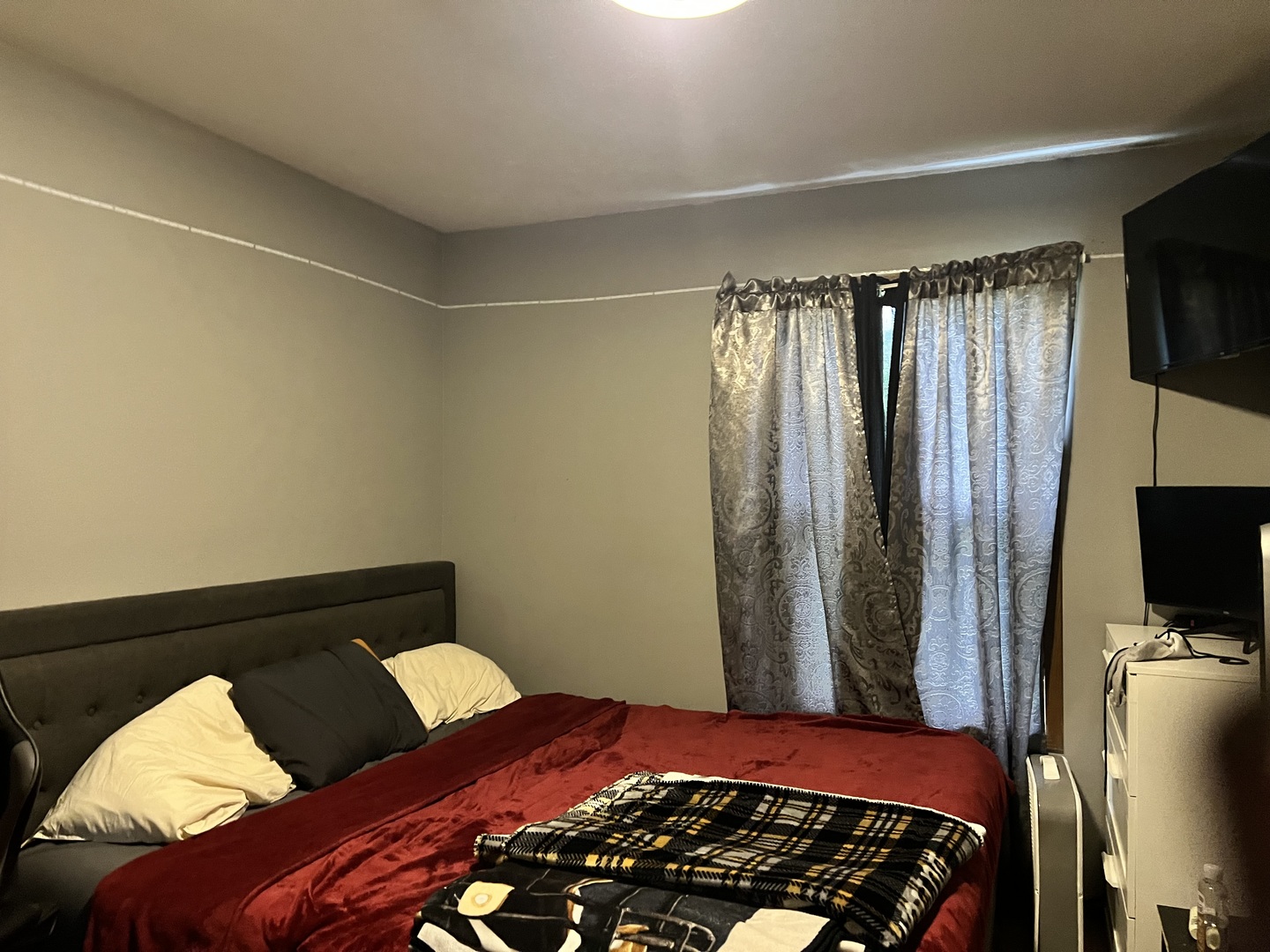 841 South High Street Paxton, IL 60957 - Photo 4 of 6 a bedroom with a bed and a flat tv screen on a dresser