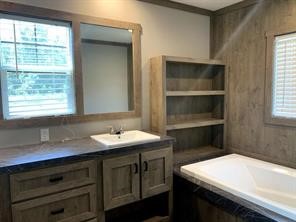 95 Pine Ridge Drive Cleveland, TX 77327 - Photo 16 of 37 a bathroom with a sink a vanity and a window