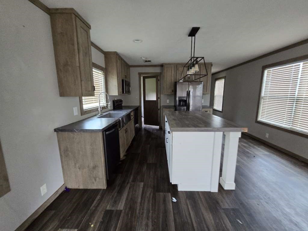 95 Pine Ridge Drive Cleveland, TX 77327 - Photo 2 of 37 a kitchen with kitchen island granite countertop a stove a sink a refrigerator and wooden floors