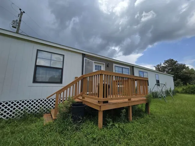a view of a backyard with sitting area