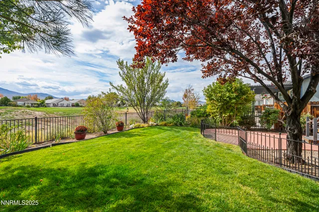 a view of yard with green space and wooden fence