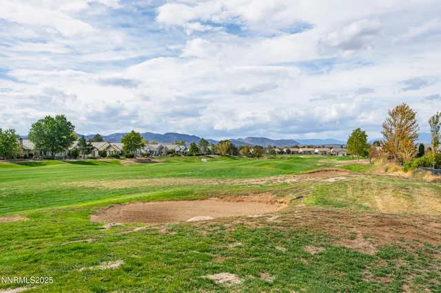 a view of a garden with wooden fence