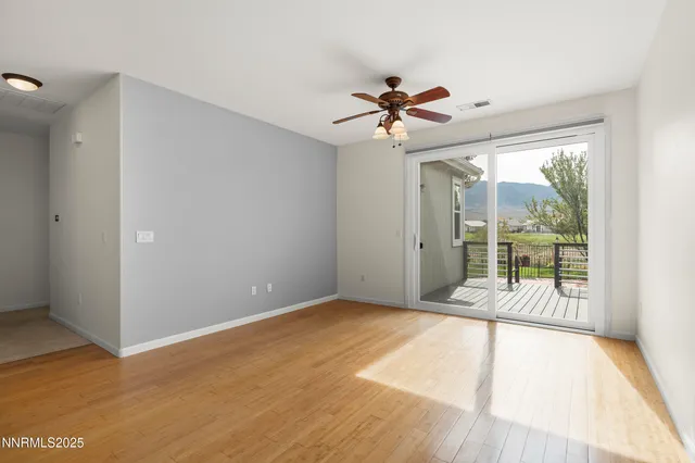 a view of a room with a ceiling fan and a large window