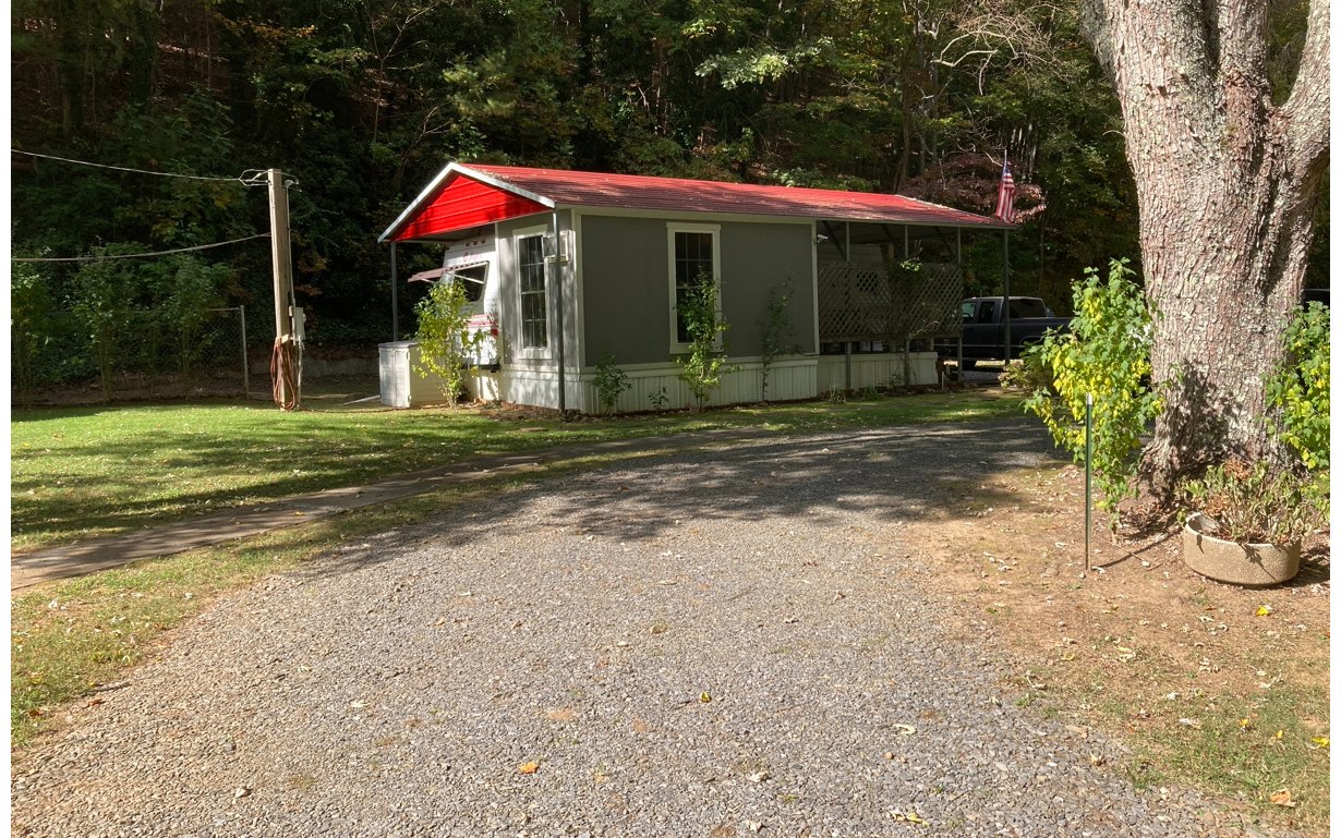 1300 Candy Mountain Road Murphy, NC 28906 - Photo 1 of 27 a view of a white house with a small yard and large trees