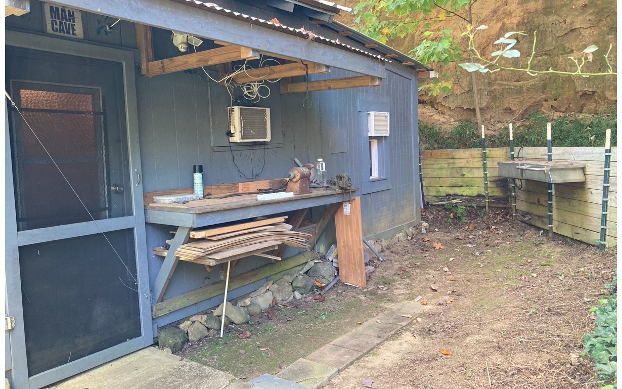 1300 Candy Mountain Road Murphy, NC 28906 - Photo 12 of 27 a backyard of a house with a fountain table and chairs