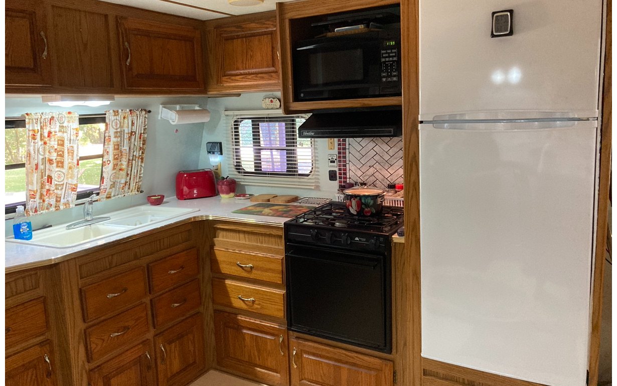 1300 Candy Mountain Road Murphy, NC 28906 - Photo 7 of 27 a kitchen with a refrigerator and a stove top oven