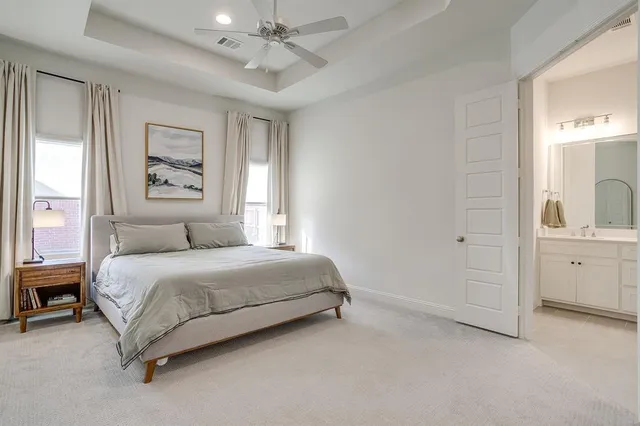 a spacious bedroom with a bed a window and closet