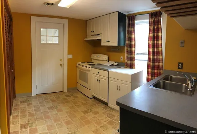 a kitchen that has a sink and a stove