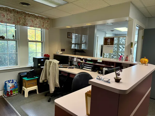 a kitchen that has a sink a stove and a table in it