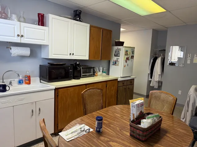 a kitchen with stainless steel appliances kitchen island granite countertop a sink dishwasher a stove a refrigerator and cabinets with wooden floor