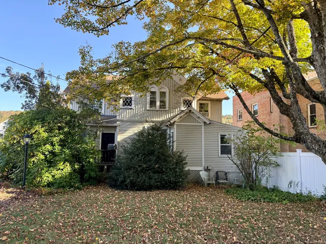 front view of a house with a tree