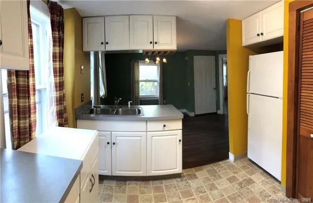 a kitchen with kitchen island a sink stainless steel appliances and cabinets