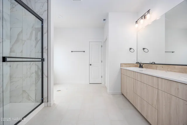 a bathroom with a double vanity sink and a mirror