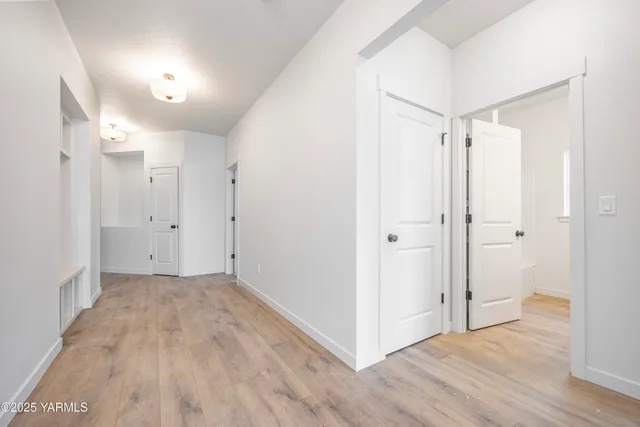 a view of a hallway with wooden floor