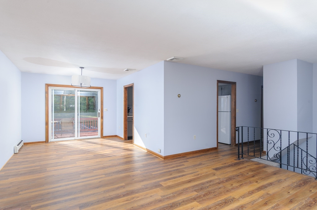 280 South Barre Road Barre, MA 01005 - Photo 4 of 25 a view of an empty room with wooden floor and a window