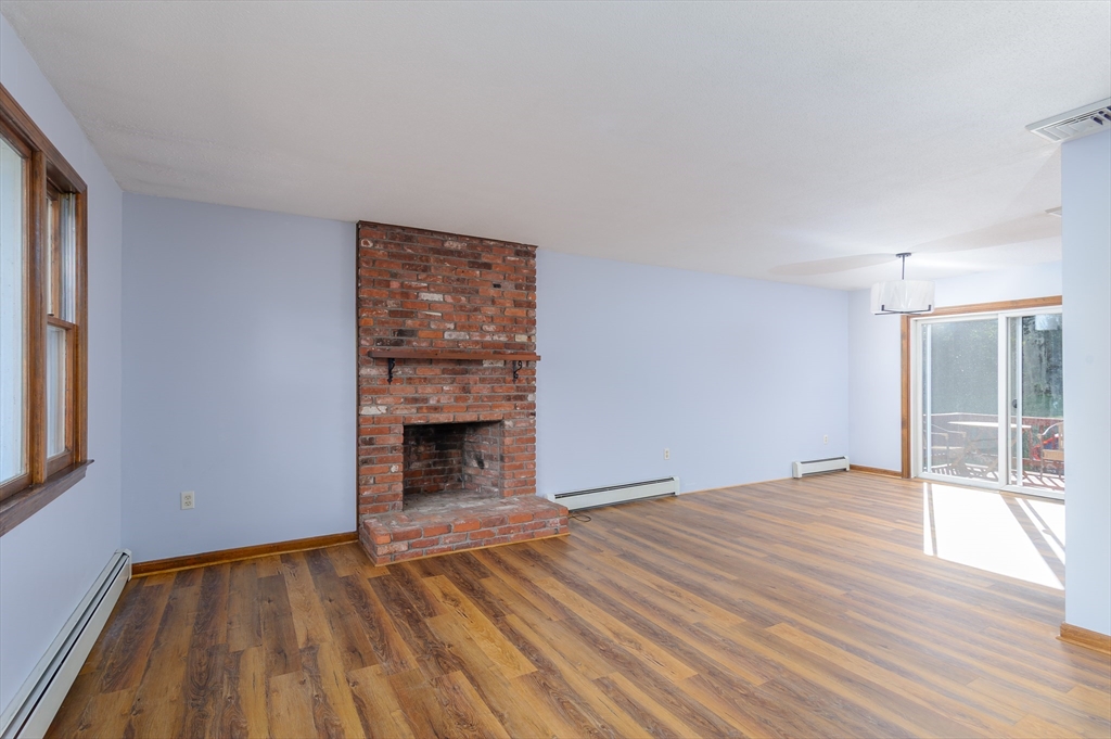 280 South Barre Road Barre, MA 01005 - Photo 5 of 25 a view of an empty room with wooden floor fireplace and a window