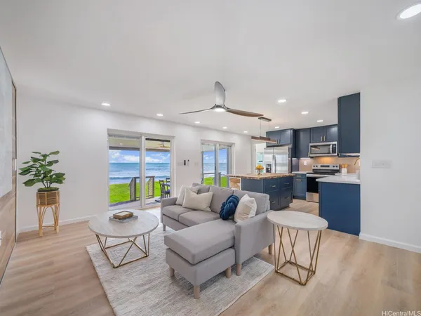 a living room with furniture kitchen and a table