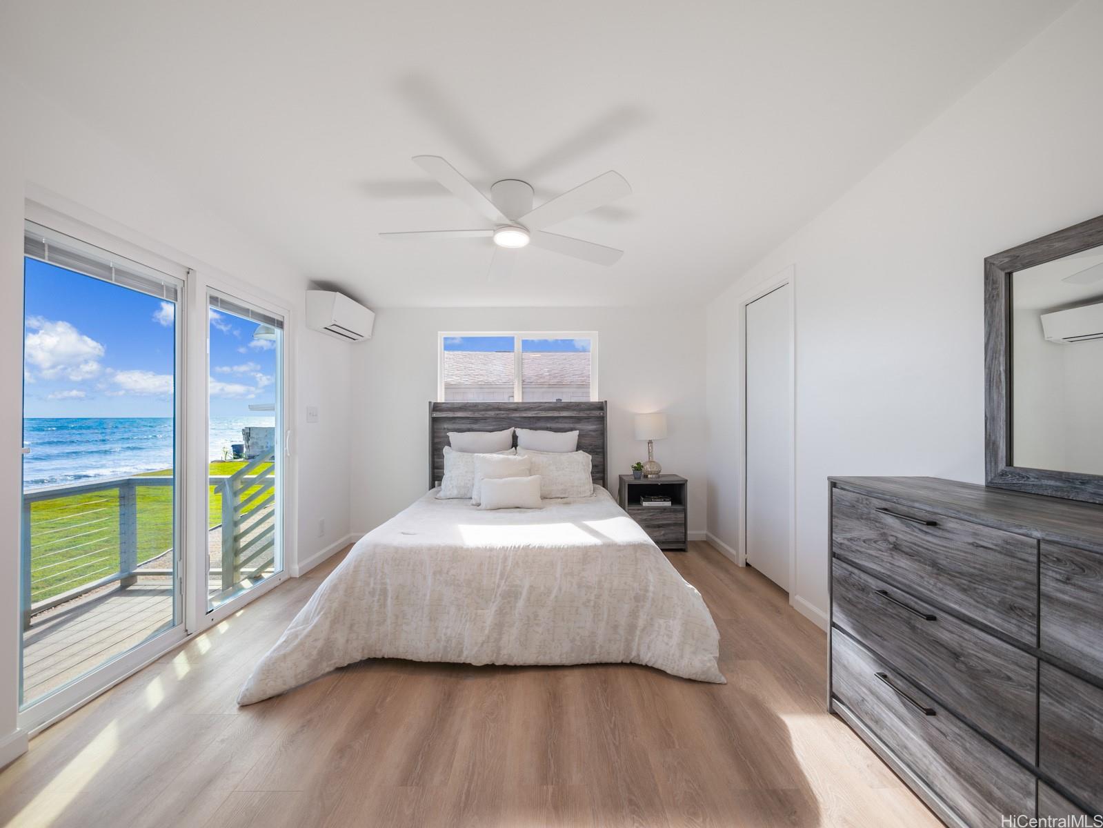 91-481 Ewa Beach Road, Unit C Ewa Beach, HI 96706 - Photo 13 of 25 a bedroom with a bed and a large window