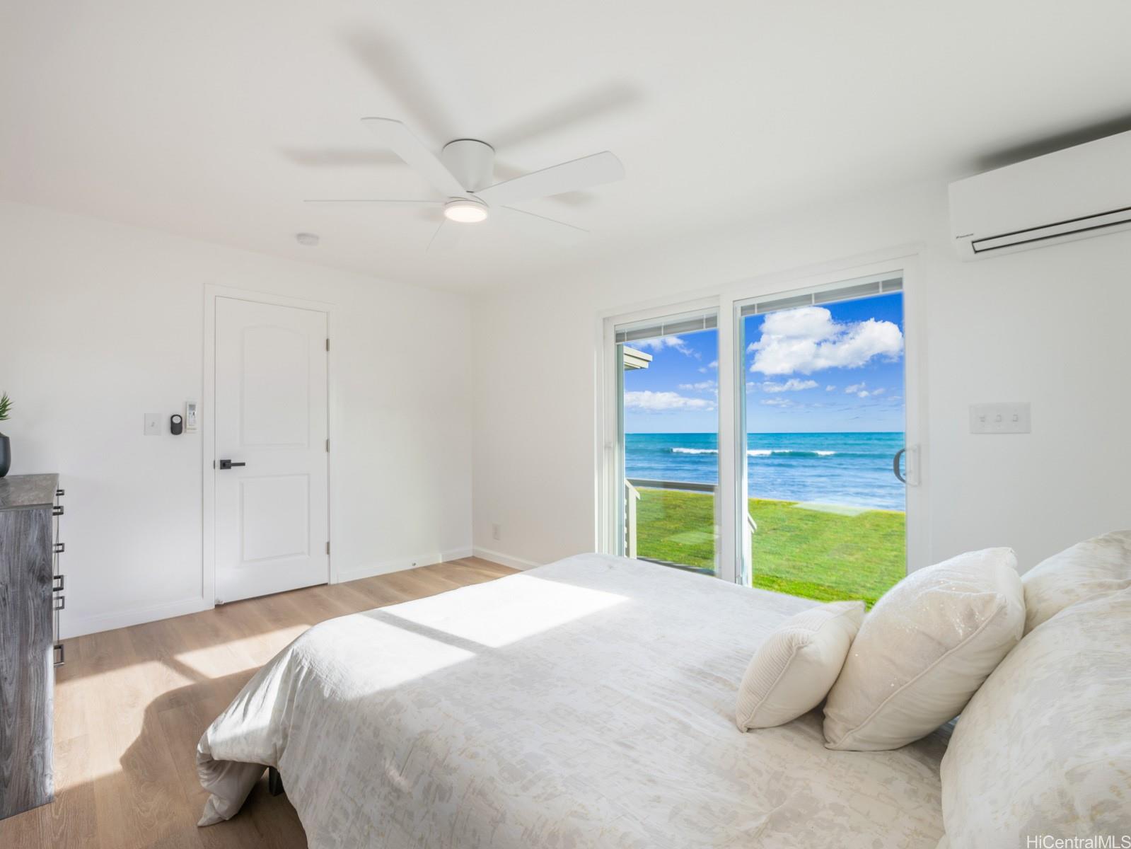 91-481 Ewa Beach Road, Unit C Ewa Beach, HI 96706 - Photo 14 of 25 a bedroom with a bed and a large window