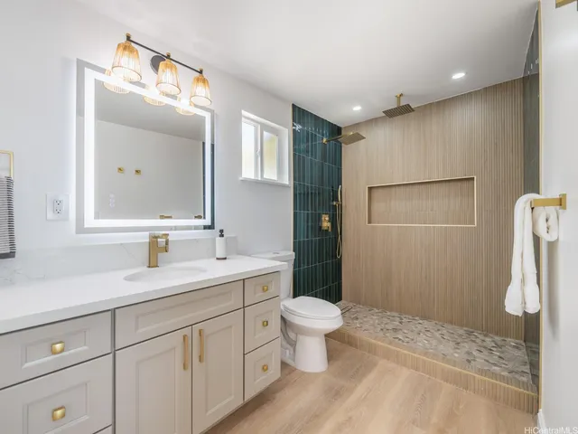 a bathroom with a toilet sink and mirror
