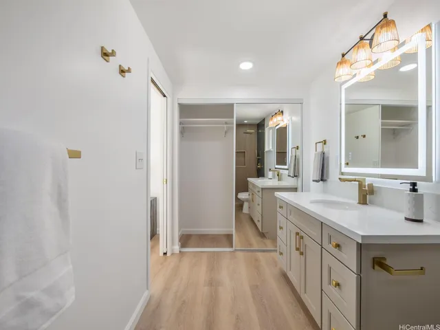 a spacious bathroom with a double vanity sink and mirror