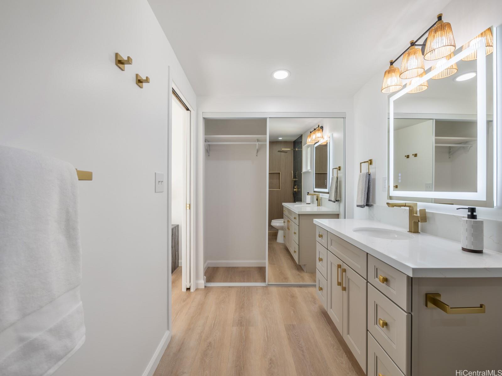 91-481 Ewa Beach Road, Unit C Ewa Beach, HI 96706 - Photo 17 of 25 a spacious bathroom with a double vanity sink and mirror
